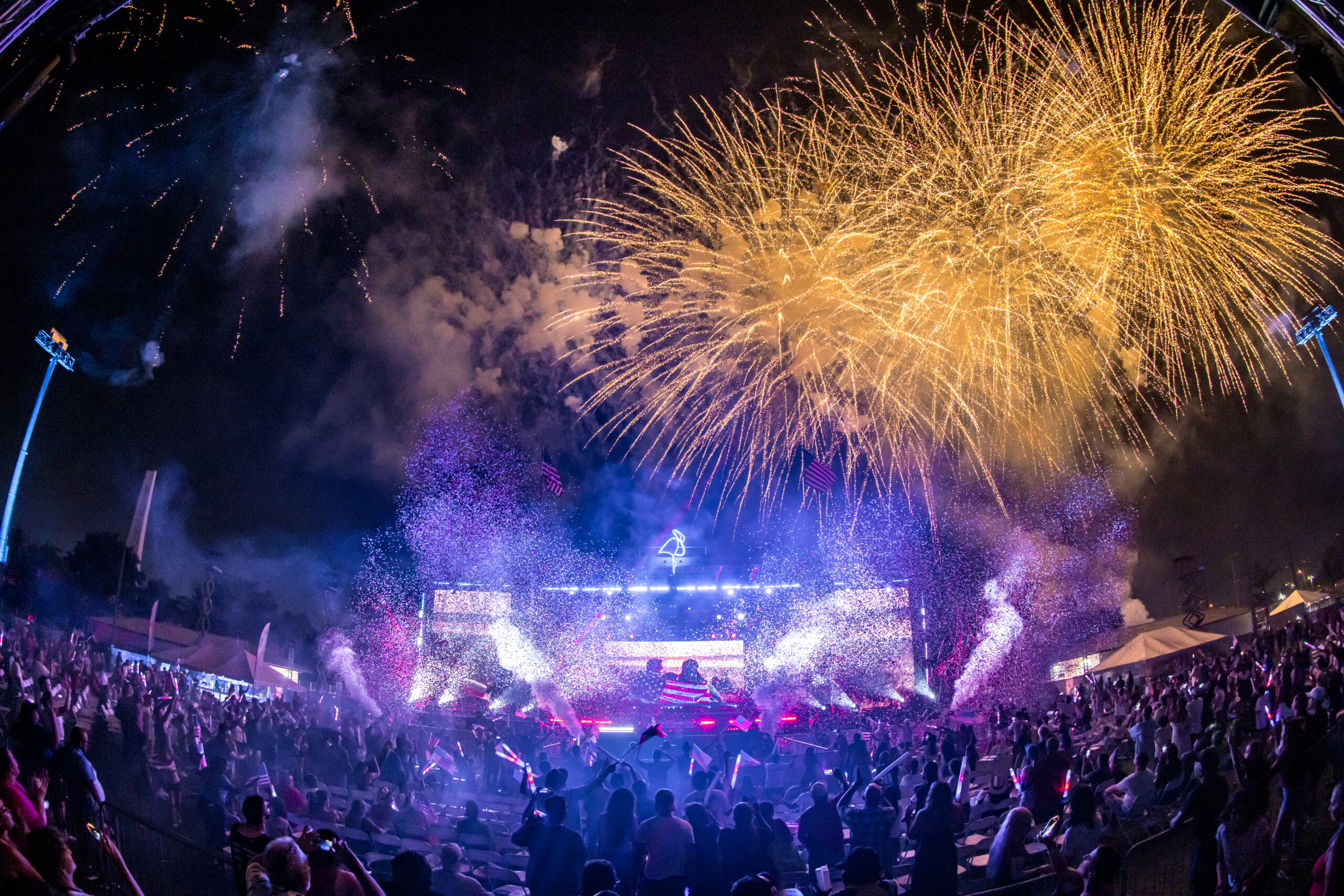 Picture of the crowd looking at the stage and the fireworks